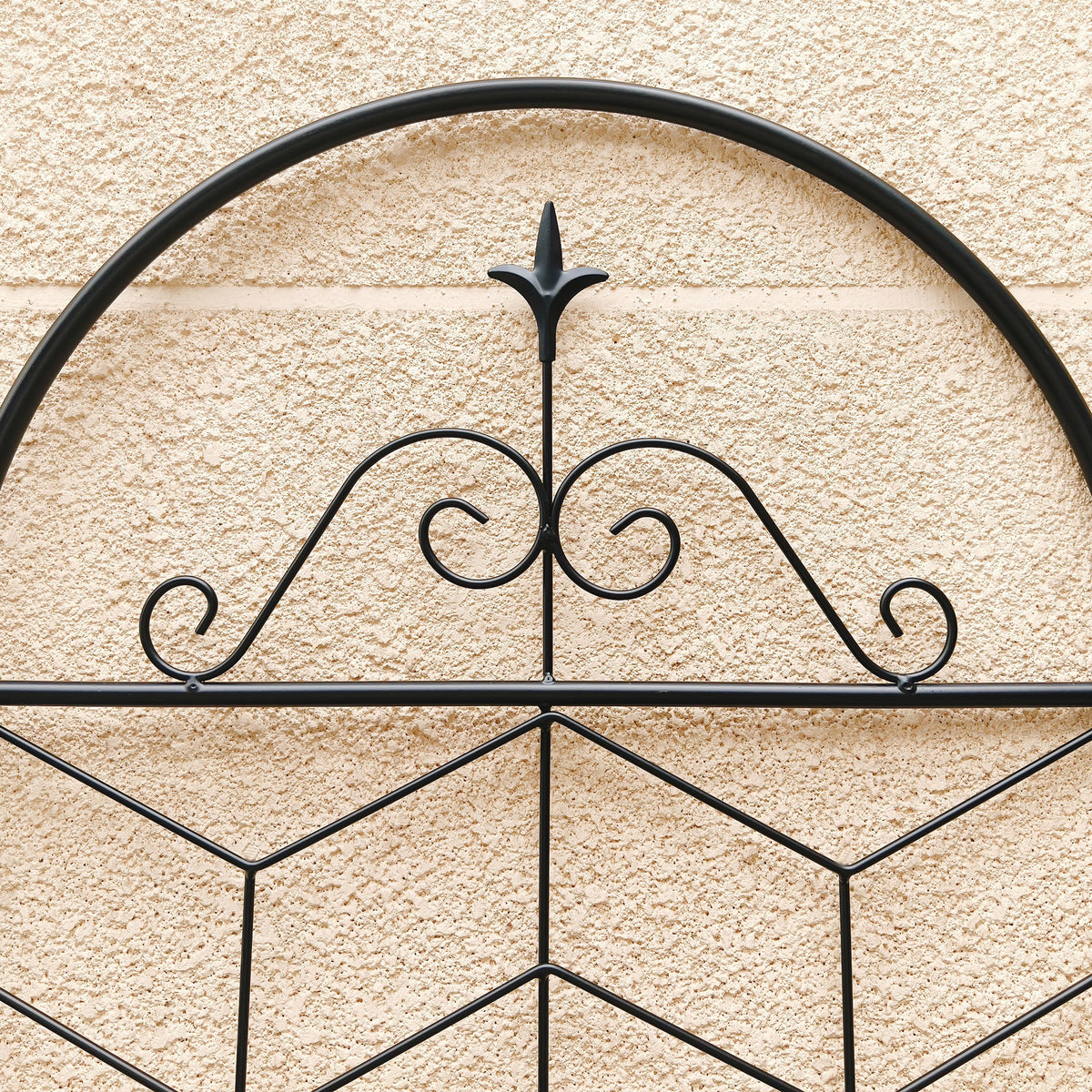Close-up of rustproof black metal trellis showing intricate fleur-de-lis and scrollwork accents